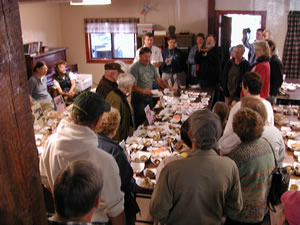 people gathered around tables of mushrooms